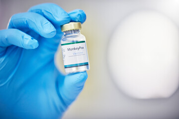 Poster - Innovation, healthcare or hand with vaccine, medicine or product in bottle with a blurry or blurred background. Monkey pox, doctor or scientist working on medical cure or lab drugs in safety gloves