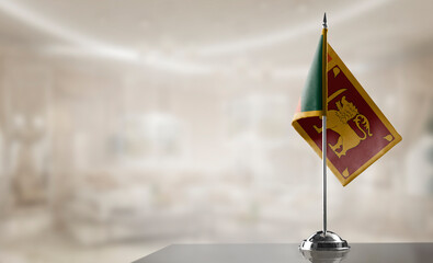 Wall Mural - A small Sri Lanka flag on an abstract blurry background