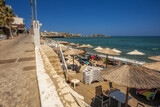Fototapeta  - View of the beach and sunbathing on the Greek island of Crete in Hersonissos