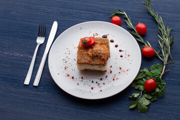 meat dish decorated with tomatoes and herbs