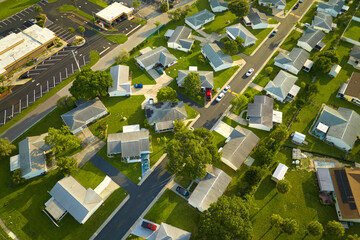 Aerial view of small town America suburban landscape with private homes between green palm trees in Florida quiet residential area