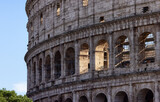 Fototapeta  - Ancient Remains in Rome, Italy. Colosseum. Sunny Cloudy Sky.
