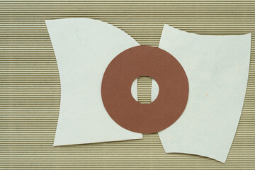 brown paper donut on two paper shapes and corrugated paper