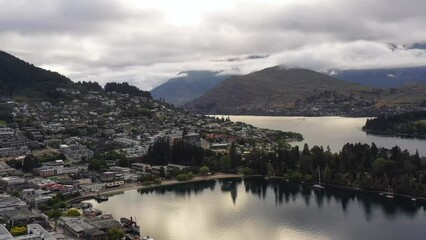 Sticker - Queenstown gardens on Wakatipu lake in New Zealand in aerial flying as 4k.
