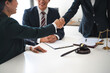 © mojo_cp - Lawyer consultant shaking hand with client sign contract agreement document. in law firm. Business meeting Handshake.  