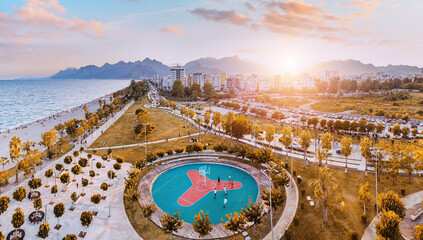 Wall Mural - Aerial view of Antalya coastal beach park with basketball playground and various hotel and residential buildings in background