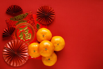 Wall Mural - Chinese new year festival decoration with red bags, oranges and red Chinese folded fans on red background.