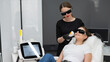 A woman on a couch in goggles undergoing a photorejuvenation procedure. Hardware cosmetology. 