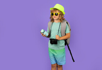 Child tourist with travel bag travelling. Kid with suitcase on studio isolated background.