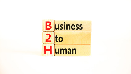 B2H business to human symbol. Concept words B2H business to human on wooden blocks on a beautiful white table white background. Business and B2H business to human concept. Copy space.