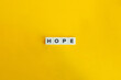 Hope Word on Block Letter Tiles on Yellow Background. Minimal Aesthetics.