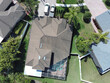 © christian.bitzas - Aerial drone image of a residential house near Tampa Florida with screen enclosure protecting pool