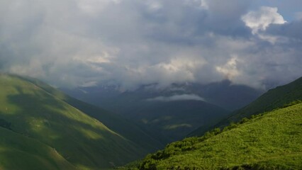 Wall Mural - beautiful landscape with mountains and clouds in dusk, caucasus, russia, zoom in timelapse 4k