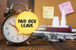 On the alarm clock a sticker with the inscription - Paid sick leave