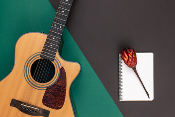 Wall Mural - Flat lay, acoustic guitar and notebook on color background.