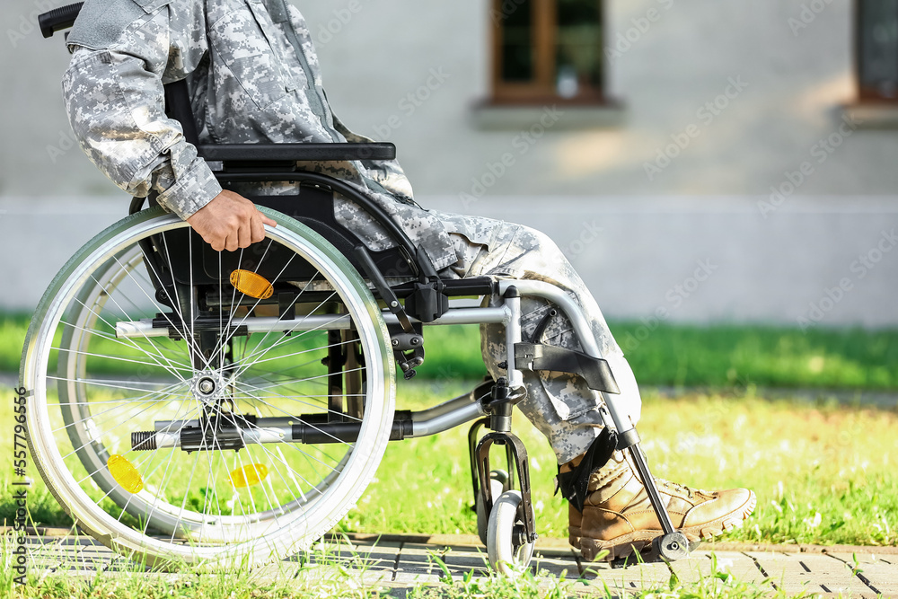 Young soldier in wheelchair outdoors