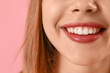 © Pixel-Shot - Young woman with beautiful smile on pink background, closeup