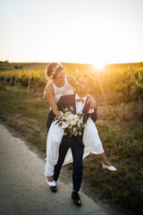 Wall Mural - Wedding in the vineyards, bride and groom in the sunset