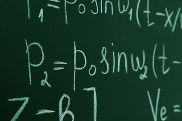 Wall Mural - Many different math formulas written on chalkboard, closeup