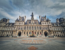 Paris City Hall, France. Outdoors View To The Beautiful Ornate Facade Of The Historical Building And The Olympic Games Rings Symbol In Front Of The Central Doors