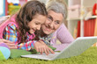 © aletia2011 - grandmother and daughter using modern laptop at home