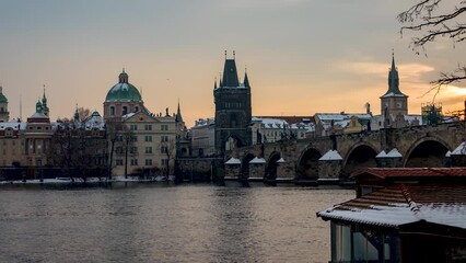 Canvas Print - Winter sunrise time lapse view of the cityscape at the snow covered old town of Prague with Charles Bridge and Vltava river, Czech Republic