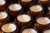 Group of Handmade Soy and coconut wax candles in a Amber and opaque container, brown glass jar. Natural eco friendly organic soy wax candles. Trendy concept diy. Vegan product. Close up