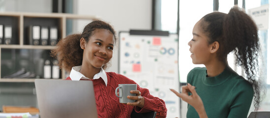 Wall Mural - African American girls students studying up for test or making homework together, Back to school concept.