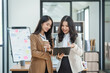© Phushutter - Asian company employees and colleagues work together in the office. by talking and giving advice to each other