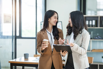 Asian company employees and colleagues work together in the office. by talking and giving advice to each other