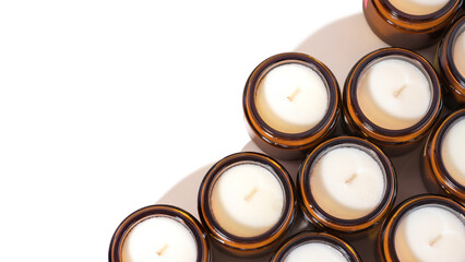 a set of different aroma soy wax scented candles in brown glass jars. natural essential candles in a