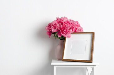 Wall Mural - Square wooden frame mockup with pink peony flowers in white room interior