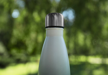 Poster - Closeup view of thermo bottle in park