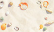Background for summer holidays. Colored seashells on sandy beach close-up.