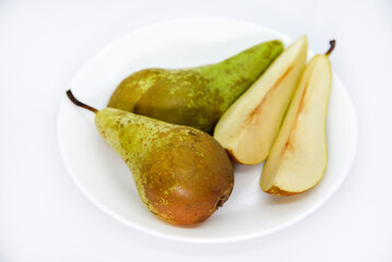 Wall Mural - Chopped green pears on a plate. Delicious pear. A served plate with a pear.
