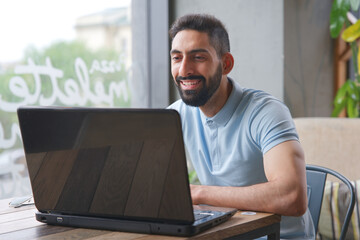 Portrait of Arab Arabian young handsome happy muslim bearded man with beard in casual clothes, islamic person 