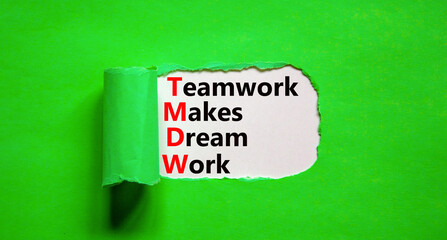 TMDW Teamwork makes dream work symbol. Concept words TMDW Teamwork makes dream work on white paper on beautiful green background. Business TMWD teamwork makes dream work concept. Copy space.