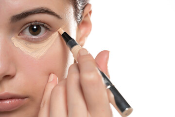 Woman  applying concealer on flawless fresh skin, doing make up. Girl  put corrector under eye area.