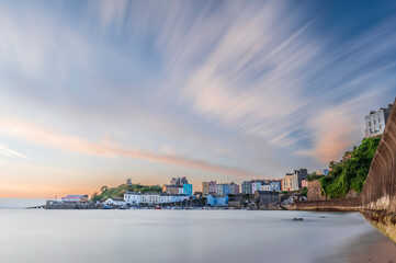 Sunrise over Tenby's harbour on a calm summer's morning. Tenby is a holiday destination on the south coast of Wales, UK