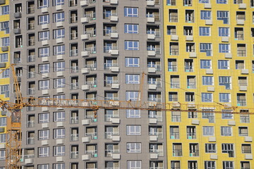 urban modern landscape and multi-colored new buildings residential buildings, windows, air conditioners, facades in winter, Biryulovo, Moscow, January 2023.