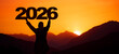 Landscape background banner panorama 2026 - Breathtaking view with black silhouette of mountains and man holding year, in the morning during the sunrise