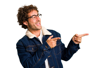 Wall Mural - Young curly smart caucasian man cut out isolated points with thumb finger away, laughing and carefree.