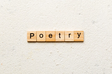 Poetry word written on wood block. Poetry text on cement table for your desing, Top view concept