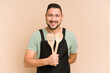 © Asier - Adult latin cook man holding wooden utensils isolated