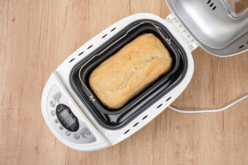 Bread mold inside the kneading barrel inside the home bread machine.