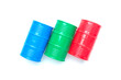 © NajmiArif - Flatlay picture of oil blue, green and red oil barrels on white background.