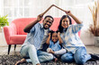 © Art_Photo - Portrait enjoy happy smiling love black family african american father and mother with young parents little asian girl sitting and making roof house with hand arm over head in new home