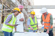 © ND STOCK - Diverse team of professionals using tablet computers on construction site. Real estate construction project. with civil engineers, architects, Arabic business investors and explorer with theodolite