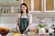 © imtmphoto - portrait of a young asian housewife standing in kitchen