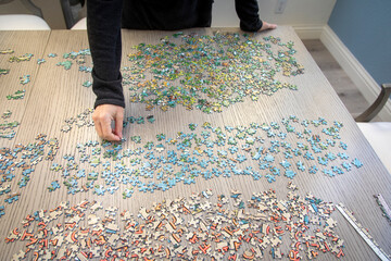 Overhead image of a woman doing a puzzle